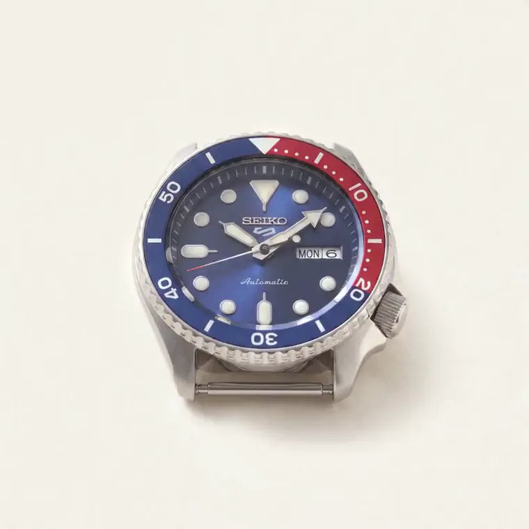 An automatic watch coming apart into its components as the page scrolls
